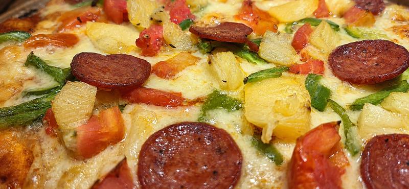 Pizza — up close, golden and bubbling